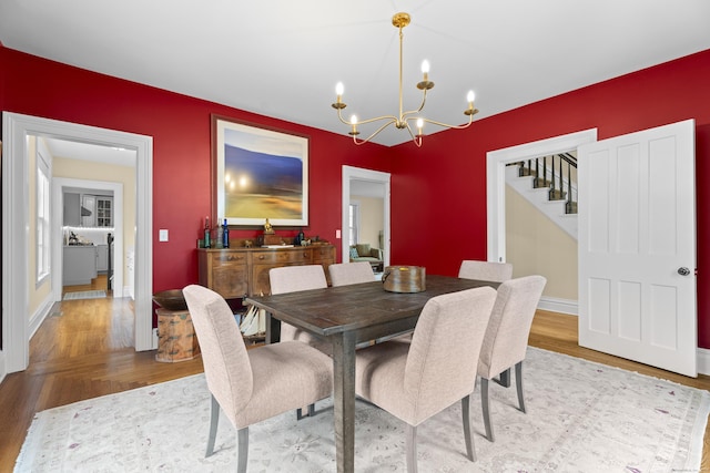 9 Rathbun Pl, Groton, CT 06355 - dining space featuring a chandelier, wood finished floors, stairway, and baseboards