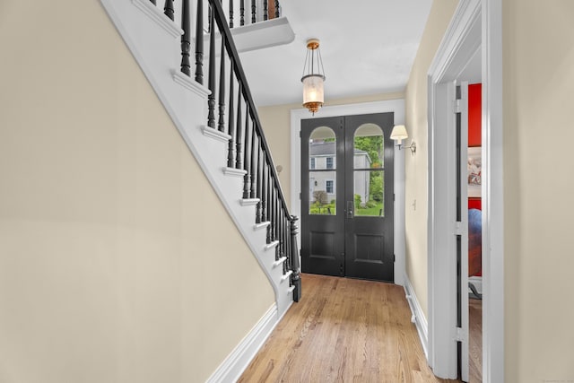 9 Rathbun Pl, Groton, CT 06355 - foyer with wood finished floors, baseboards, stairs, and french doors