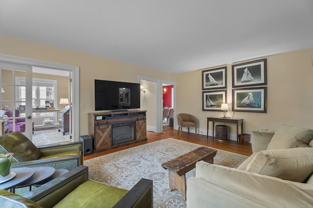 9 Rathbun Pl, Groton, CT 06355 - living room with wood finished floors, baseboards, and a fireplace
