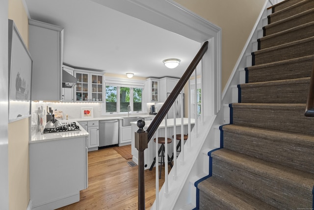 9 Rathbun Pl, Groton, CT 06355 - staircase featuring wood finished floors and wet bar