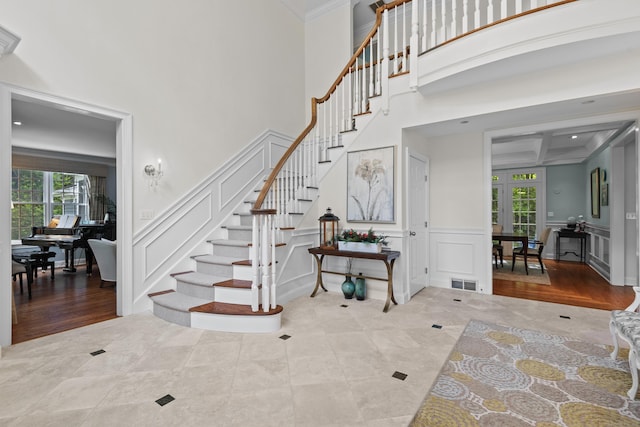 8 Hollow Oak Rd, Woodbridge, CT 06525 - stairway with a decorative wall, coffered ceiling, crown molding, tile patterned flooring, and beamed ceiling