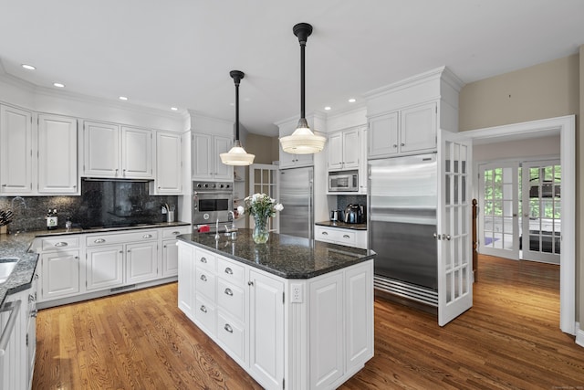 8 Hollow Oak Rd, Woodbridge, CT 06525 - kitchen featuring built in appliances, wood finished floors, decorative backsplash, white cabinets, and recessed lighting
