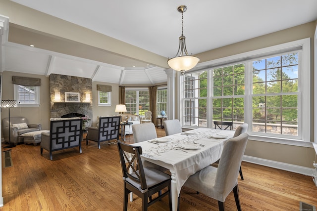 8 Hollow Oak Rd, Woodbridge, CT 06525 - dining area with a stone fireplace, beamed ceiling, and wood finished floors