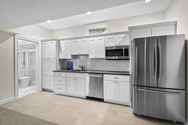 8 Hollow Oak Rd, Woodbridge, CT 06525 - kitchen with stainless steel appliances, dark countertops, backsplash, recessed lighting, and white cabinets