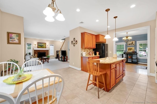 244 S St, Vernon, CT 06066 - kitchen with a chandelier, freestanding refrigerator, open floor plan, light tile patterned floors, and recessed lighting