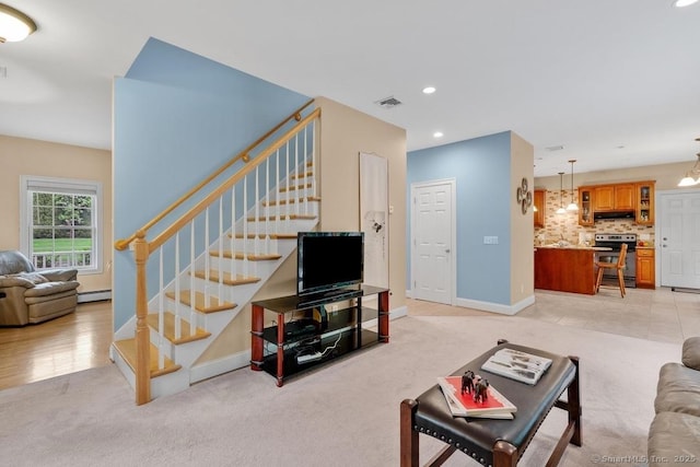 244 S St, Vernon, CT 06066 - living area featuring stairs, recessed lighting, a baseboard radiator, light colored carpet, and baseboards