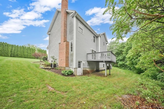 244 S St, Vernon, CT 06066 - back of house featuring a chimney, a lawn, a wooden deck, and central AC