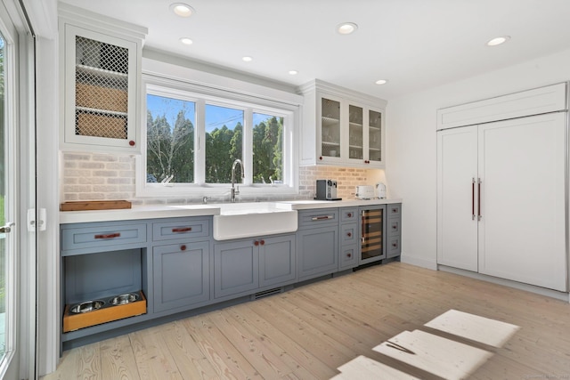 5 Compo Hill Ave, Westport, CT 06880 - indoor bar with beverage cooler, paneled built in fridge, light wood-style flooring, tasteful backsplash, and recessed lighting