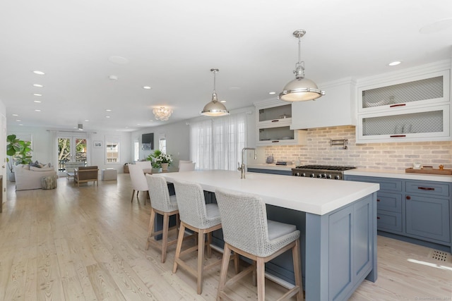 5 Compo Hill Ave, Westport, CT 06880 - kitchen with a kitchen bar, light countertops, backsplash, recessed lighting, and open floor plan