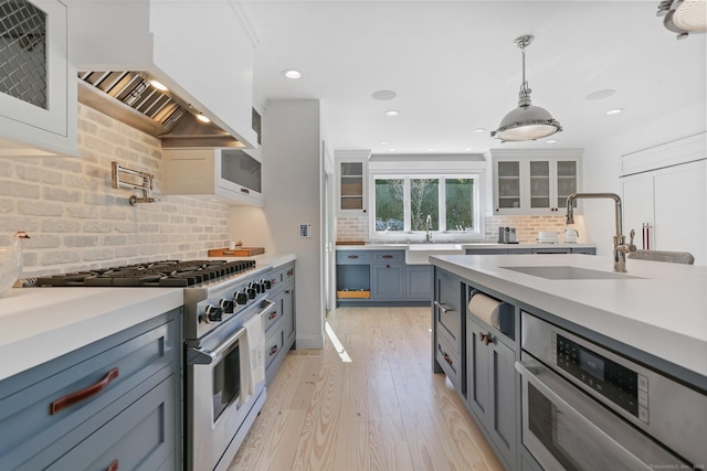 5 Compo Hill Ave, Westport, CT 06880 - kitchen with stainless steel appliances, custom range hood, a sink, light countertops, and recessed lighting