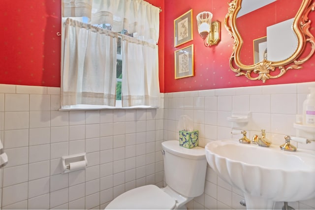 10 Crossland Pl, Norwalk, CT 06851 - bathroom with toilet, tile walls, a wainscoted wall, and a sink