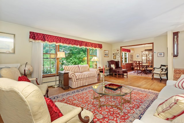 10 Crossland Pl, Norwalk, CT 06851 - living room featuring baseboard heating, wood finished floors, and a chandelier