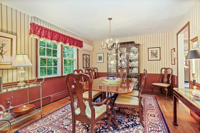 10 Crossland Pl, Norwalk, CT 06851 - dining room with wood finished floors, a wall mounted air conditioner, a chandelier, wainscoting, and wallpapered walls