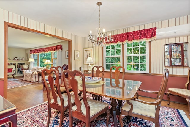10 Crossland Pl, Norwalk, CT 06851 - dining space with wallpapered walls, a chandelier, wood finished floors, and a wall unit AC