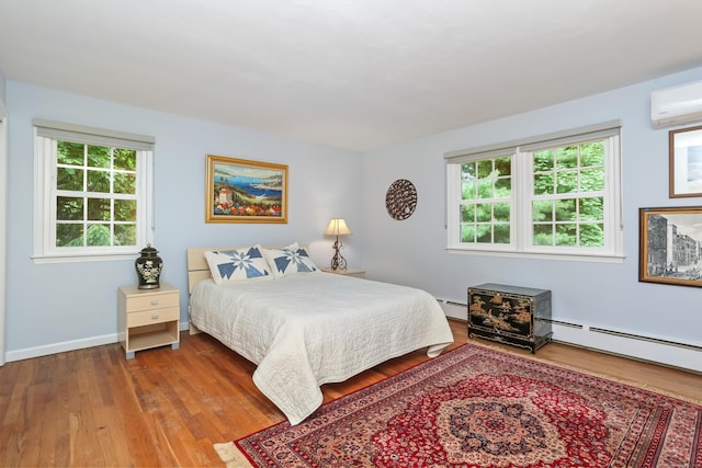 10 Crossland Pl, Norwalk, CT 06851 - bedroom with multiple windows, wood finished floors, a wall mounted air conditioner, and baseboards