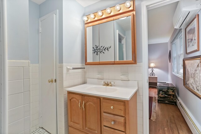 10 Crossland Pl, Norwalk, CT 06851 - bathroom featuring a baseboard heating unit, a wall mounted AC, vanity, and wood finished floors