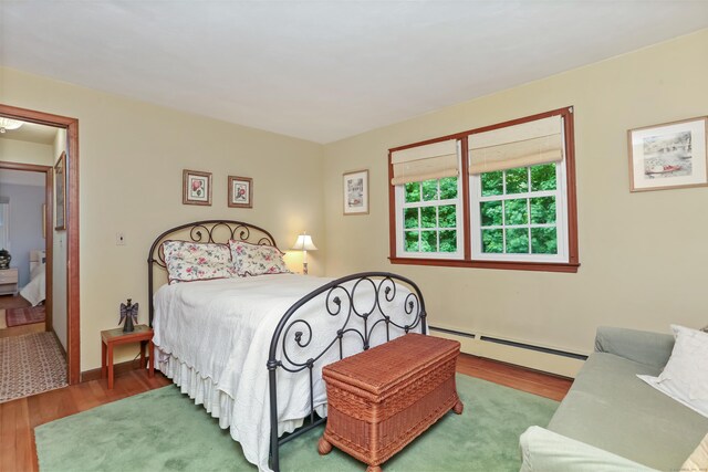 10 Crossland Pl, Norwalk, CT 06851 - bedroom featuring a baseboard radiator, wood finished floors, and baseboards