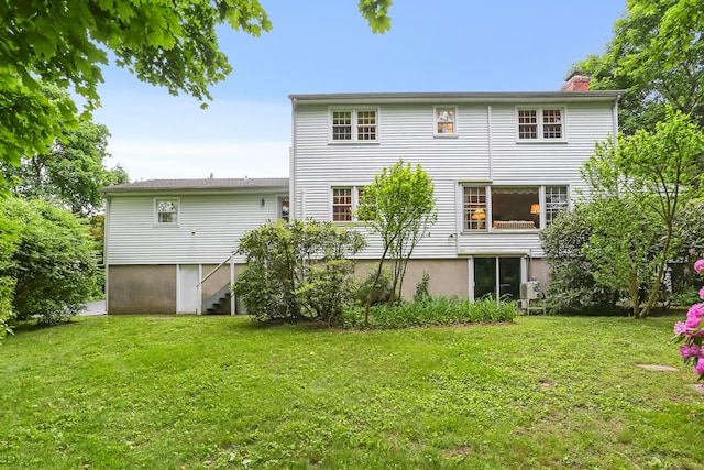 10 Crossland Pl, Norwalk, CT 06851 - rear view of property featuring a chimney and a yard