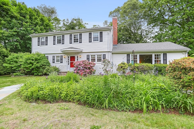 10 Crossland Pl, Norwalk, CT 06851 - colonial-style house featuring a chimney and a front lawn