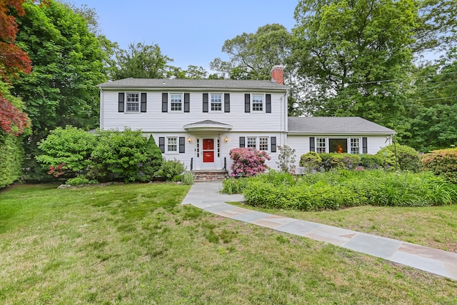 10 Crossland Pl, Norwalk, CT 06851 - colonial house featuring a chimney and a front lawn