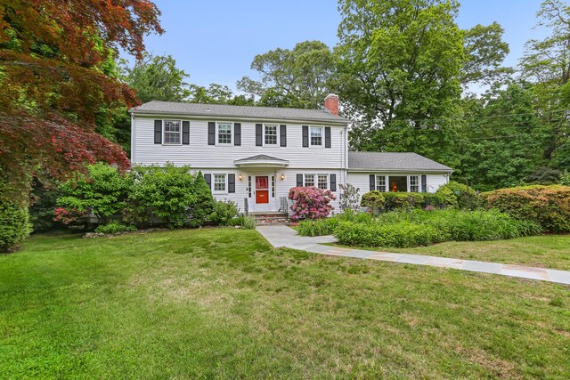 10 Crossland Pl, Norwalk, CT 06851 - colonial inspired home with a chimney and a front yard