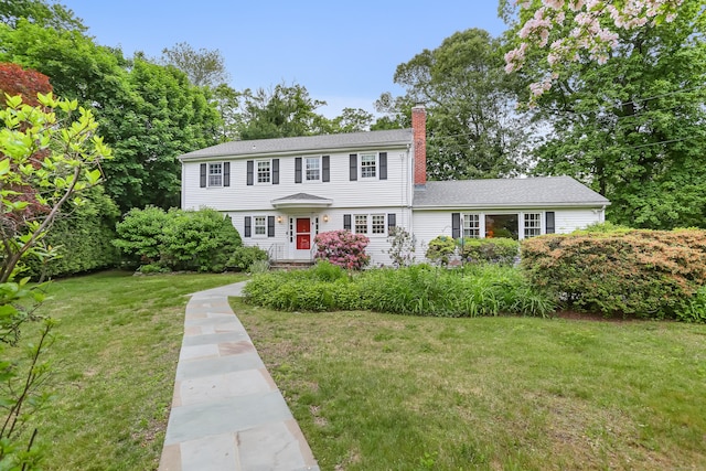10 Crossland Pl, Norwalk, CT 06851 - colonial inspired home featuring a chimney and a front yard