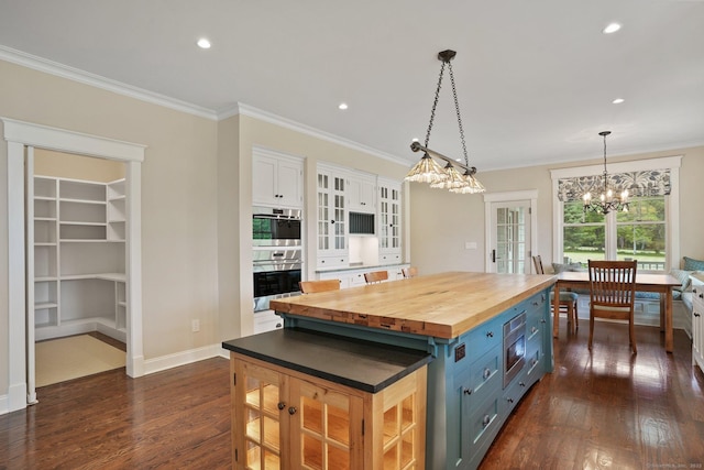 128 Chestnut Hill Rd, Killingworth, CT 06419 - kitchen with wood counters, stainless steel double oven, white cabinets, blue cabinetry, and ornamental molding