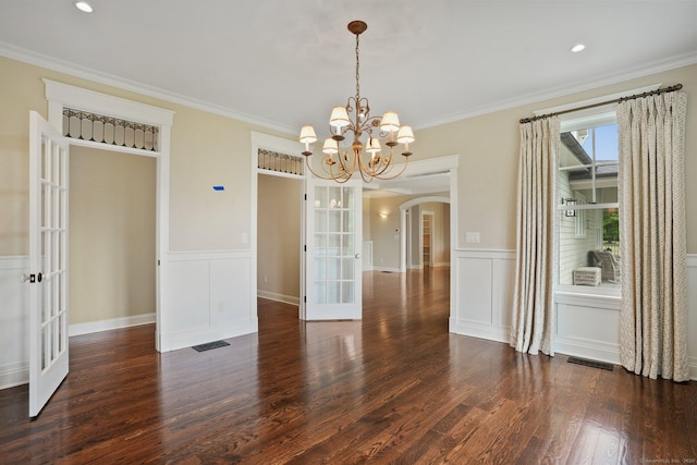 128 Chestnut Hill Rd, Killingworth, CT 06419 - unfurnished dining area with french doors, wood finished floors, arched walkways, crown molding, and a chandelier