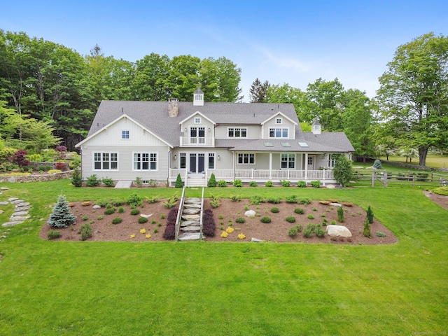 128 Chestnut Hill Rd, Killingworth, CT 06419 - rear view of property with a chimney, a yard, covered porch, and a shingled roof