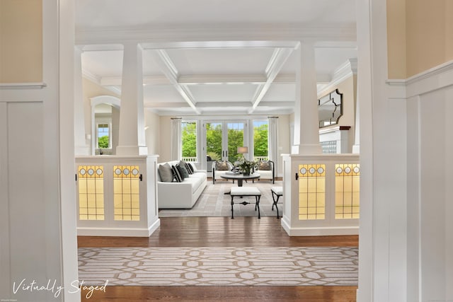 128 Chestnut Hill Rd, Killingworth, CT 06419 - living room with beamed ceiling, coffered ceiling, wood finished floors, ornamental molding, and a decorative wall