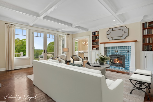 128 Chestnut Hill Rd, Killingworth, CT 06419 - living area with coffered ceiling, wood finished floors, a tiled fireplace, a chandelier, and beamed ceiling