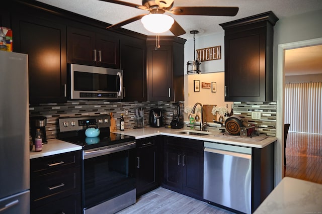 196 New Haven Ave Unit 217, Derby, CT 06418 - kitchen featuring stainless steel appliances, a sink, a ceiling fan, light countertops, and decorative backsplash