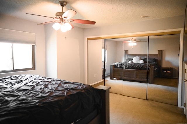 196 New Haven Ave Unit 217, Derby, CT 06418 - carpeted bedroom with a closet, a textured ceiling, and a ceiling fan