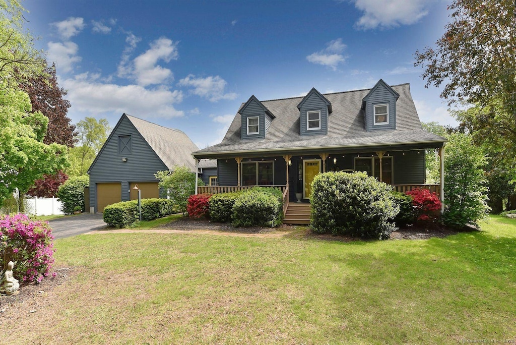 60 Haddam Neck Rd, East Hampton, CT 06424 - cape cod home featuring a garage, a porch, a front lawn, and driveway