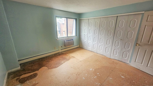 300 High Path Rd Unit 300, Windsor, CT 06095 - unfurnished bedroom with a wall mounted AC, baseboard heating, a textured ceiling, and a closet
