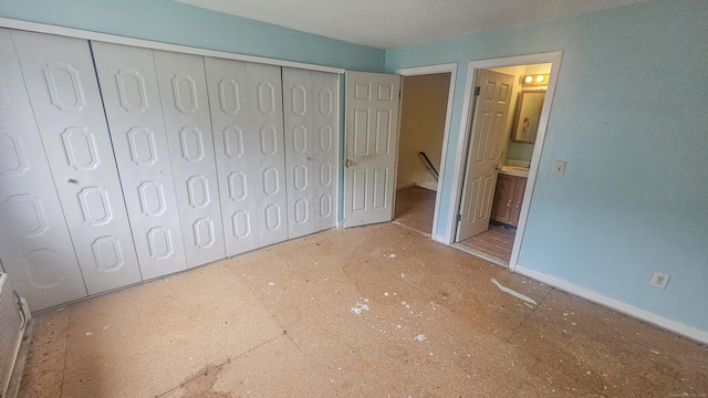 300 High Path Rd Unit 300, Windsor, CT 06095 - unfurnished bedroom with a closet, connected bathroom, and baseboards