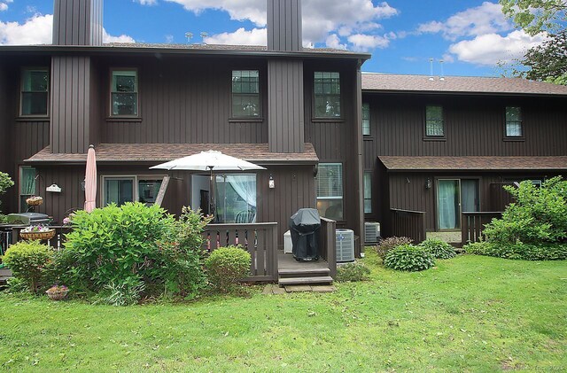 198 Mattabasset Dr Unit 198, Meriden, CT 06450 - back of property featuring a chimney, a lawn, and roof with shingles