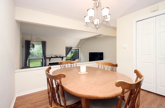 198 Mattabasset Dr Unit 198, Meriden, CT 06450 - dining space with light wood-style floors, a chandelier, vaulted ceiling, and baseboards