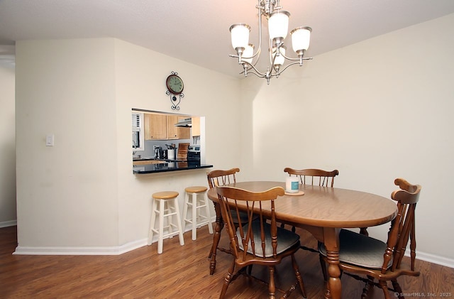 198 Mattabasset Dr Unit 198, Meriden, CT 06450 - dining area with baseboards, a chandelier, and wood finished floors