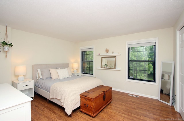 198 Mattabasset Dr Unit 198, Meriden, CT 06450 - bedroom with multiple windows, wood finished floors, and baseboards
