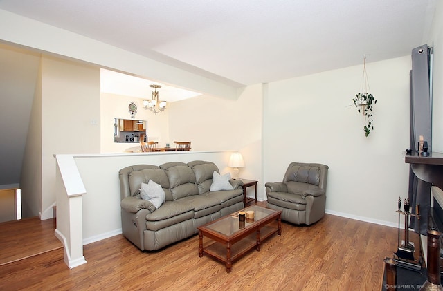 198 Mattabasset Dr Unit 198, Meriden, CT 06450 - living room with wood finished floors, a chandelier, and baseboards