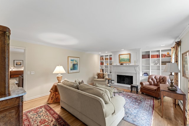 6 Middlebrook Pond Rd, Redding, CT 06896 - living room featuring light wood-type flooring, crown molding, a fireplace with raised hearth, and recessed lighting