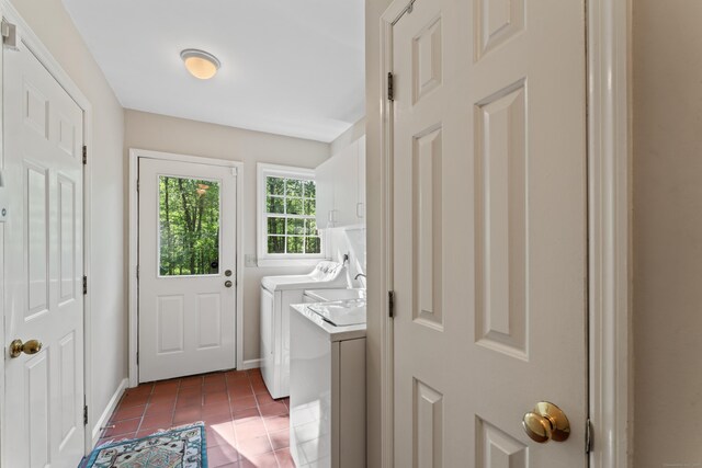 6 Middlebrook Pond Rd, Redding, CT 06896 - washroom with washer and clothes dryer, cabinet space, dark tile patterned floors, and baseboards