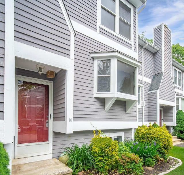 309 Terrace Ave Unit 18, West Haven, CT 06516 - view of exterior entry with a chimney