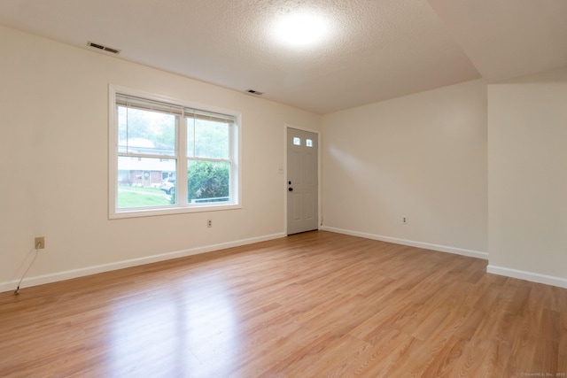 146 Macarthur Dr Unit 2B, Waterbury, CT 06704 - spare room with light wood-style flooring, a textured ceiling, and baseboards
