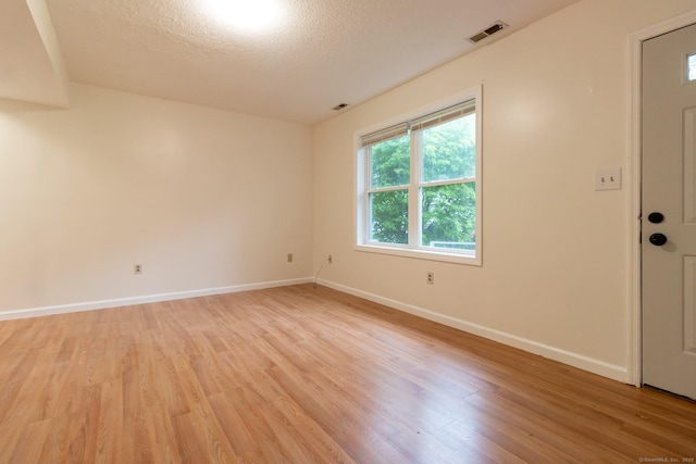 146 Macarthur Dr Unit 2B, Waterbury, CT 06704 - unfurnished room with light wood-style floors, baseboards, and a textured ceiling