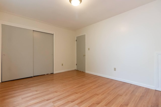 146 Macarthur Dr Unit 2B, Waterbury, CT 06704 - unfurnished bedroom with light wood-type flooring, baseboards, and a closet
