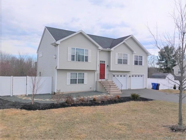 986 E St S, Suffield, CT 06078 - split foyer home with an attached garage and asphalt driveway