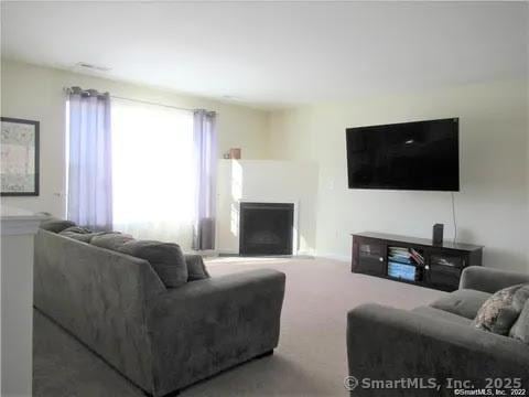 986 E St S, Suffield, CT 06078 - living room with carpet and a fireplace