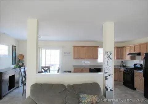 986 E St S, Suffield, CT 06078 - kitchen with black appliances, under cabinet range hood, plenty of natural light, and brown cabinets